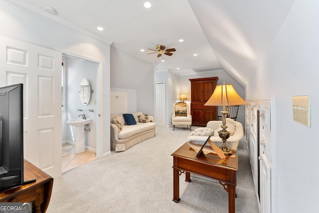 living room with ceiling fan, sink, light colored carpet, crown molding, and vaulted ceiling