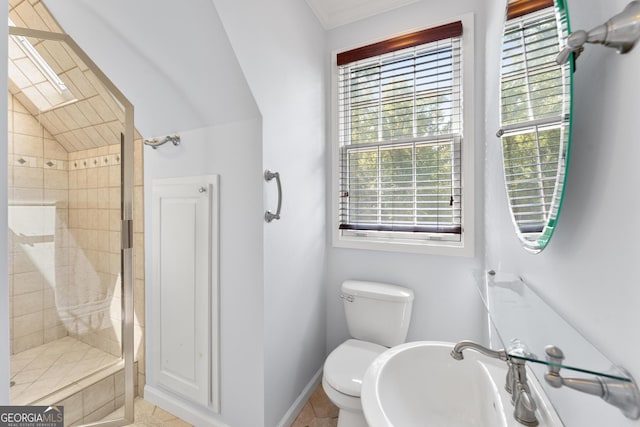 bathroom with sink, tile patterned floors, toilet, and tiled shower