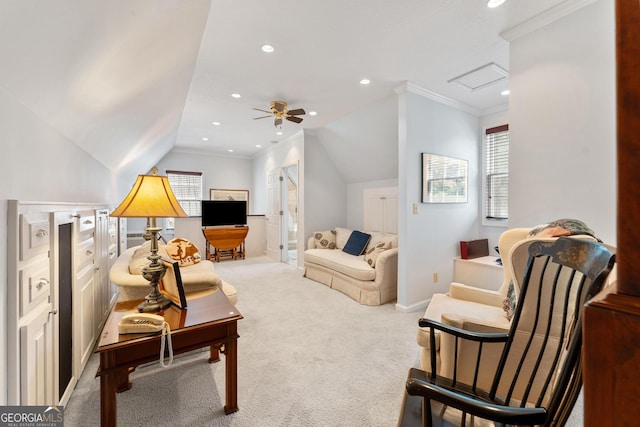 carpeted living room with ceiling fan, crown molding, and vaulted ceiling