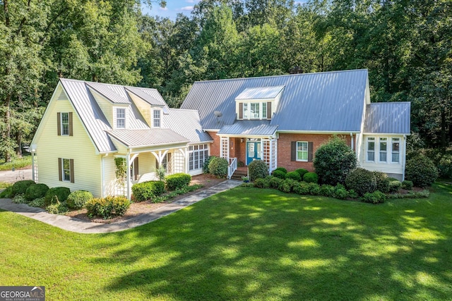 cape cod-style house with a front lawn