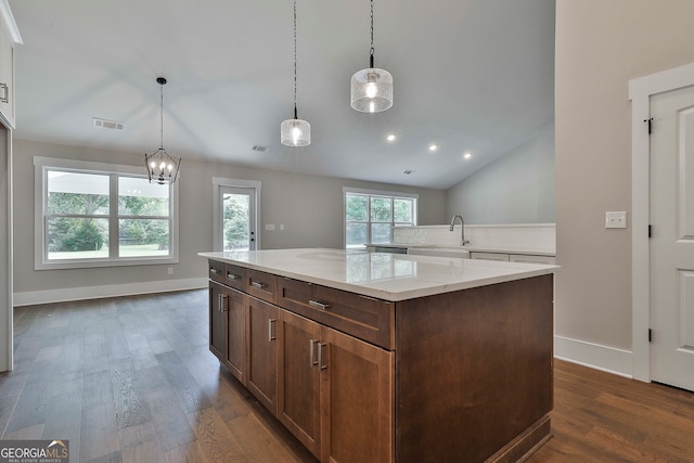 kitchen with dark hardwood / wood-style flooring, hanging light fixtures, and vaulted ceiling