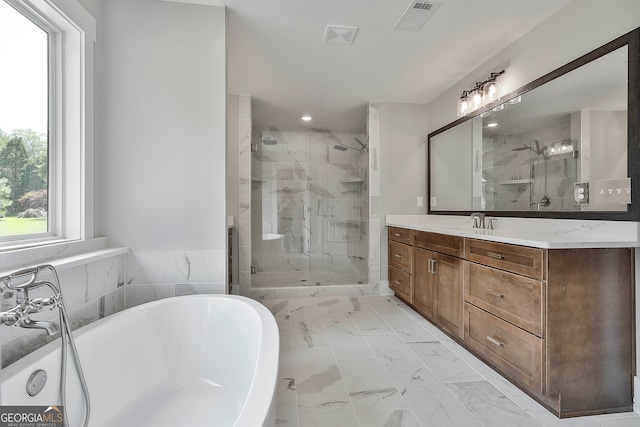 bathroom with vanity and separate shower and tub