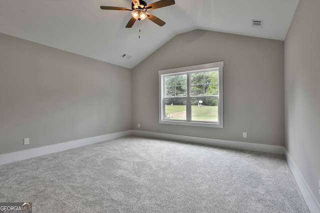 carpeted empty room with lofted ceiling and ceiling fan