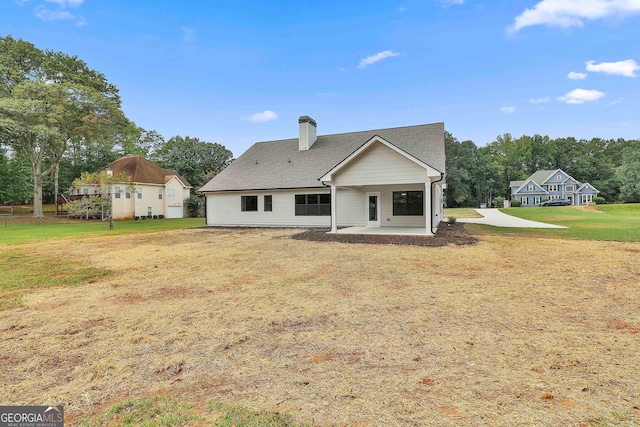 rear view of property with a lawn