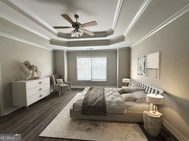 bedroom with ceiling fan, a raised ceiling, crown molding, and dark hardwood / wood-style flooring