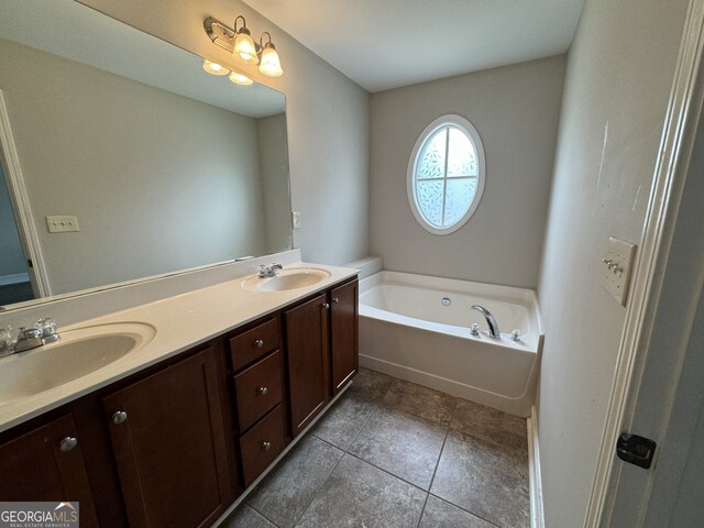 bathroom with vanity, a washtub, and tile patterned floors