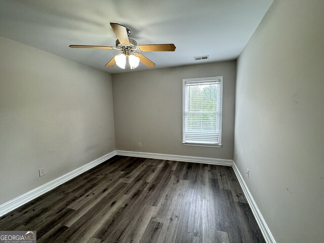 unfurnished room featuring ceiling fan and dark hardwood / wood-style flooring