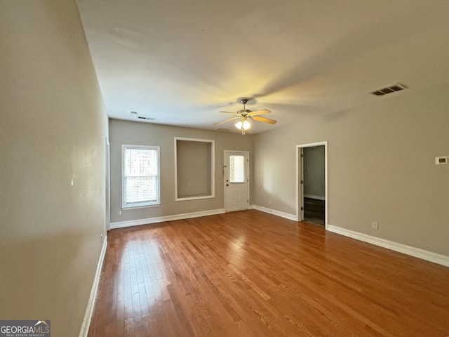 spare room with ceiling fan and hardwood / wood-style flooring