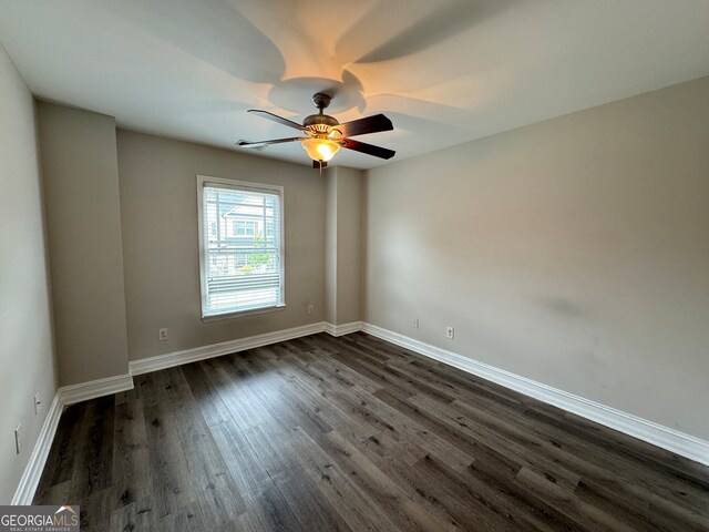 unfurnished room featuring ceiling fan and dark hardwood / wood-style flooring