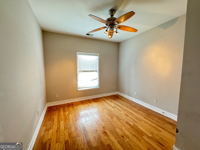 spare room featuring ceiling fan and light hardwood / wood-style flooring