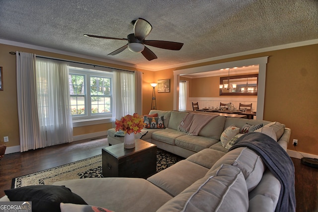 living room with ceiling fan, hardwood / wood-style flooring, crown molding, and a textured ceiling