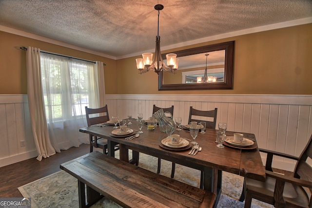 dining room featuring a chandelier, a textured ceiling, and dark wood-type flooring