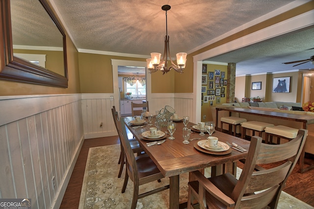 dining room with sink, a textured ceiling, dark wood-type flooring, ceiling fan with notable chandelier, and crown molding