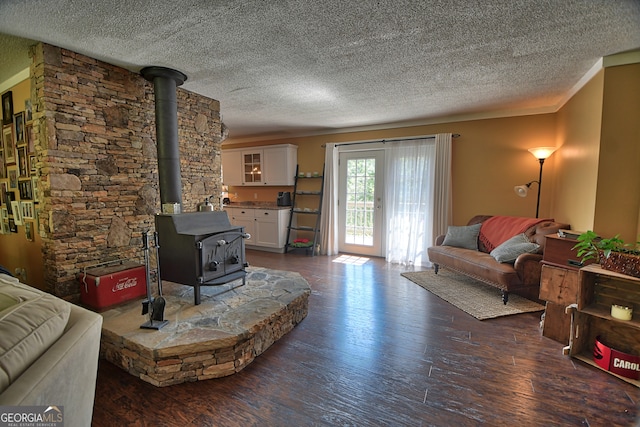 living room featuring a textured ceiling, dark hardwood / wood-style floors, and a wood stove