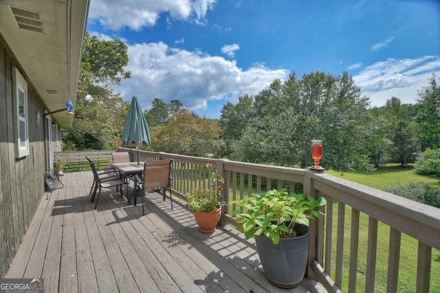 wooden deck with a yard