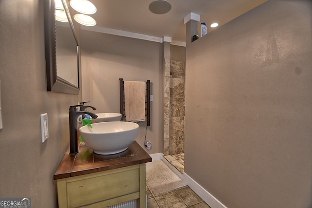 bathroom with walk in shower, vanity, and tile patterned floors