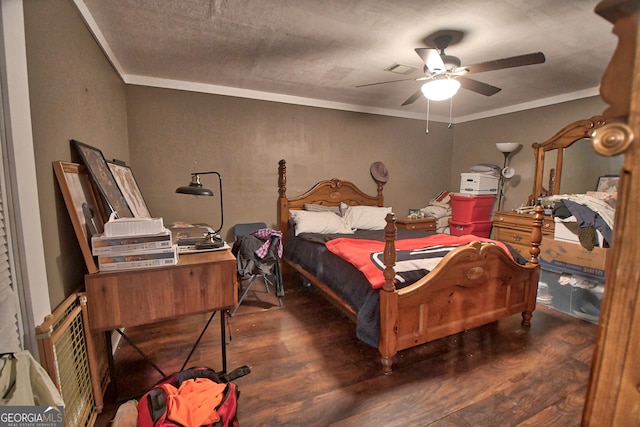 bedroom featuring ceiling fan, dark hardwood / wood-style floors, and ornamental molding