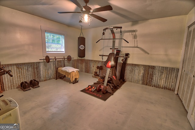 exercise room featuring ceiling fan and concrete floors