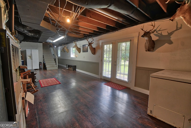 basement with a wealth of natural light and dark wood-type flooring