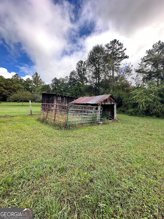 view of yard featuring an outbuilding and a rural view