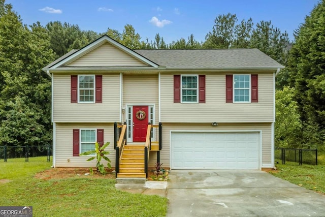 split foyer home with a front yard and a garage