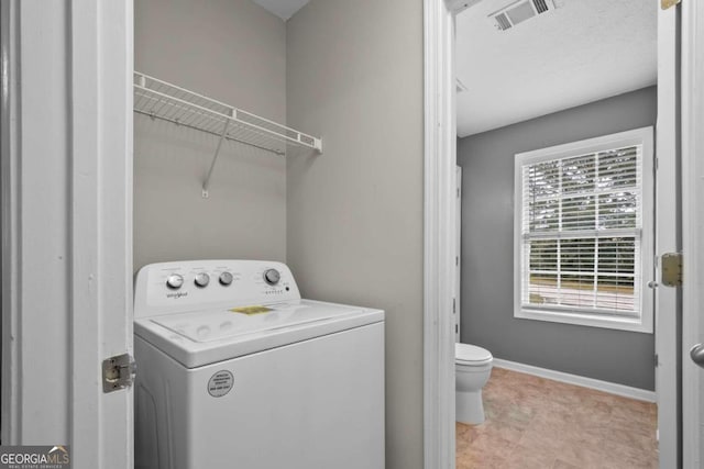 clothes washing area with washer / dryer