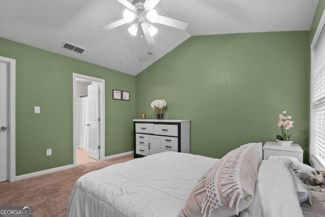 carpeted bedroom featuring ceiling fan and vaulted ceiling