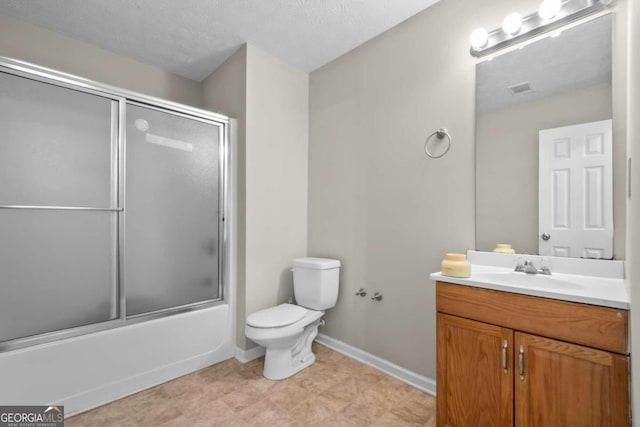 full bathroom featuring a textured ceiling, combined bath / shower with glass door, vanity, and toilet