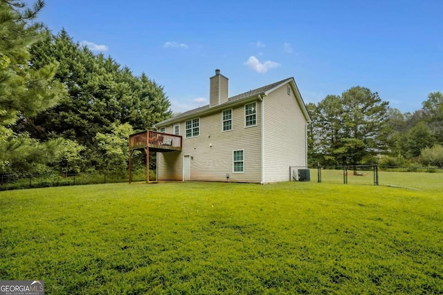 view of side of home with a deck and a lawn