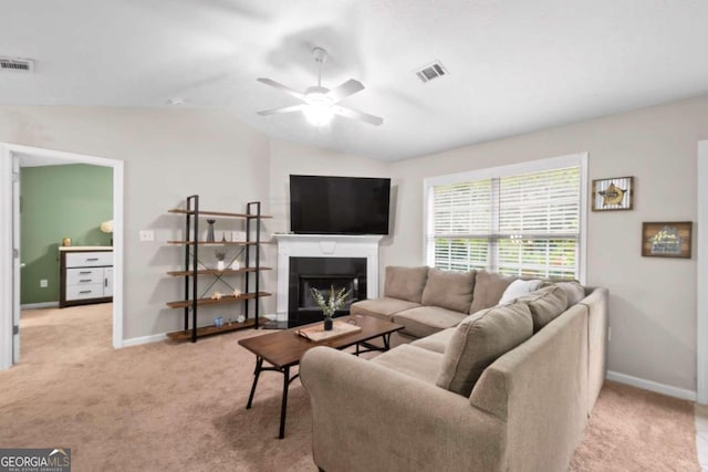 living room with lofted ceiling, light carpet, and ceiling fan