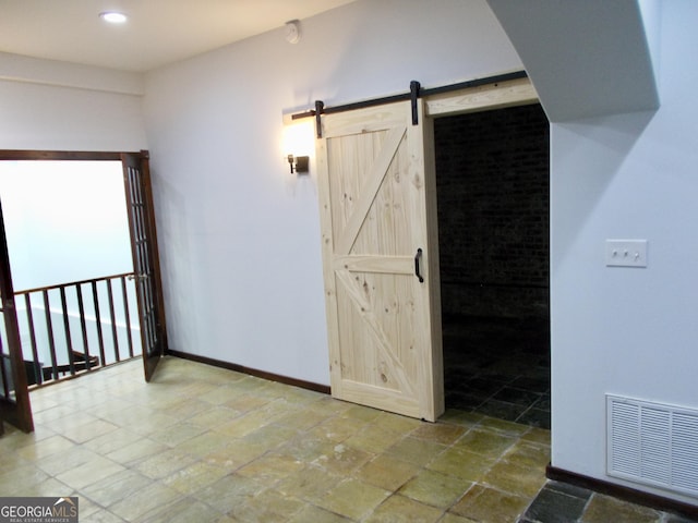 140 Walker St SW Unit A, Atlanta, GA 30313 - spare room with stone tile floors, baseboards, a barn door, and recessed lighting