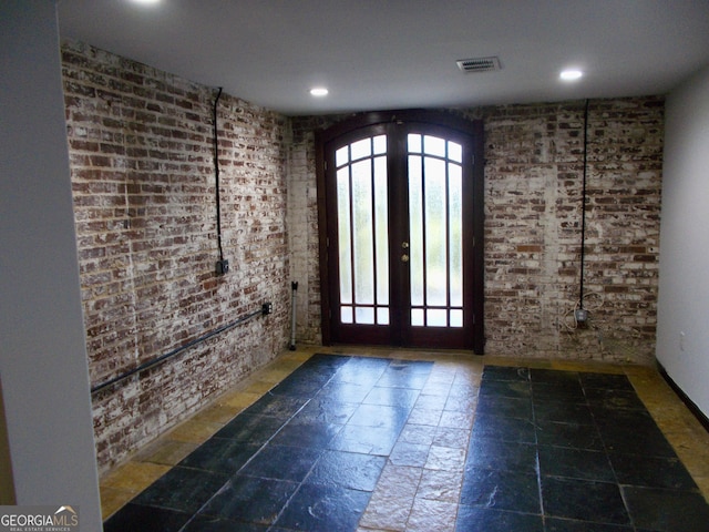 140 Walker St SW Unit A, Atlanta, GA 30313 - foyer with french doors, brick wall, healthy amount of natural light, stone tile flooring, and recessed lighting