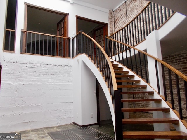 140 Walker St SW Unit A, Atlanta, GA 30313 - staircase featuring baseboards and a towering ceiling