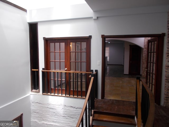 140 Walker St SW Unit A, Atlanta, GA 30313 - staircase featuring arched walkways, french doors, and stone finish flooring