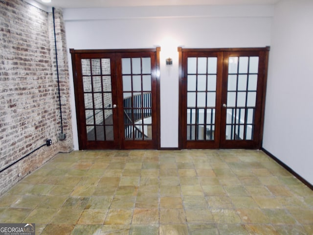 140 Walker St SW Unit A, Atlanta, GA 30313 - doorway to outside featuring french doors, stone tile floors, baseboards, and brick wall