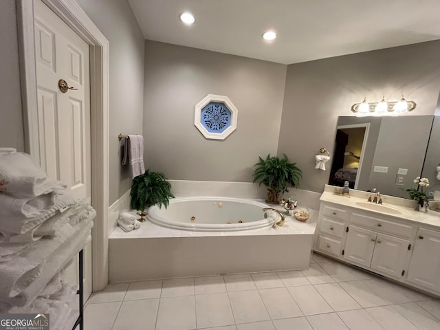 bathroom featuring tile patterned floors, tiled bath, and vanity