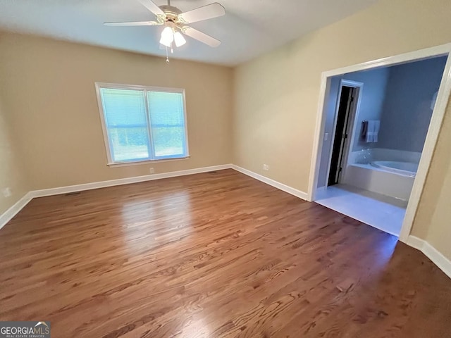 202 Maplewood Cir, Griffin, GA 30224 - unfurnished bedroom with wood finished floors, baseboards, and ceiling fan