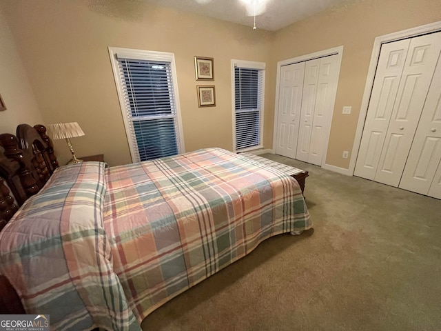 carpeted bedroom with ceiling fan and a textured ceiling