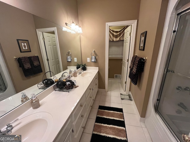 bathroom with bath / shower combo with glass door, vanity, and tile patterned floors