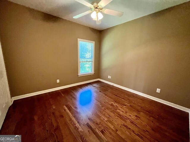 202 Maplewood Cir, Griffin, GA 30224 - unfurnished room with dark wood-style floors, baseboards, and a ceiling fan