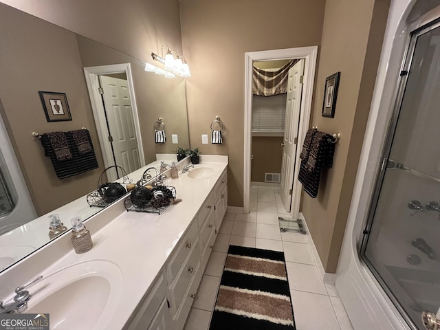202 Maplewood Cir, Griffin, GA 30224 - full bath with tile patterned flooring, double vanity, shower / bath combination with glass door, and baseboards