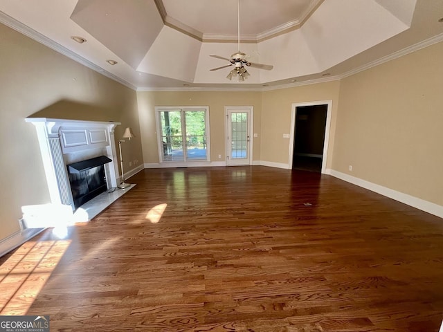 202 Maplewood Cir, Griffin, GA 30224 - unfurnished living room featuring a raised ceiling, a fireplace, wood finished floors, a ceiling fan, and baseboards