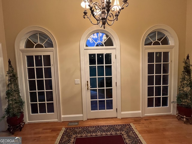 202 Maplewood Cir, Griffin, GA 30224 - doorway featuring a chandelier, wood finished floors, and baseboards