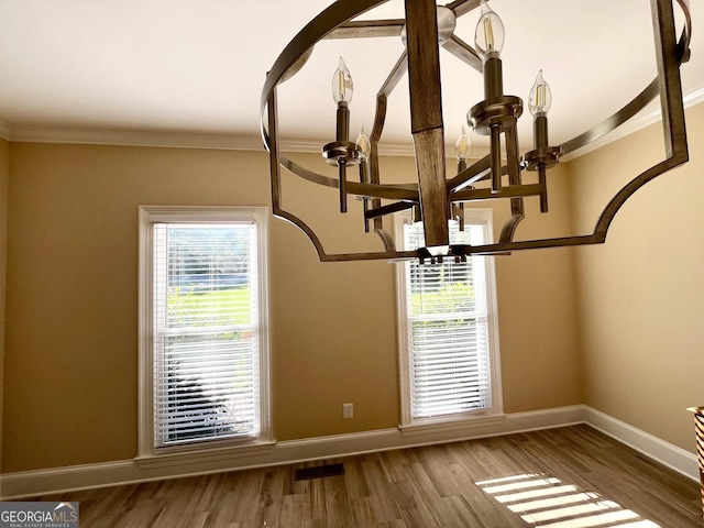 202 Maplewood Cir, Griffin, GA 30224 - detailed view of a chandelier, baseboards, ornamental molding, and wood finished floors