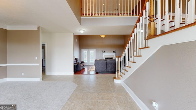 tiled foyer featuring ornamental molding