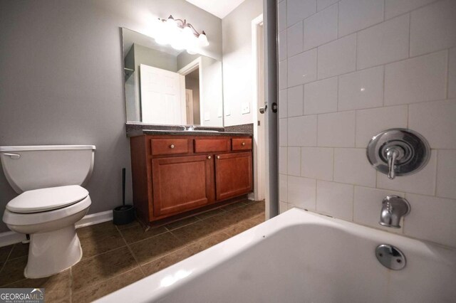 bathroom featuring a tub to relax in, tile patterned flooring, vanity, and toilet