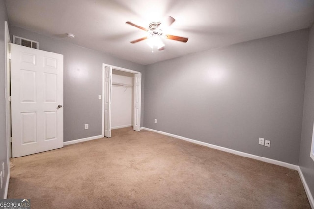 unfurnished bedroom with light carpet, a closet, and ceiling fan