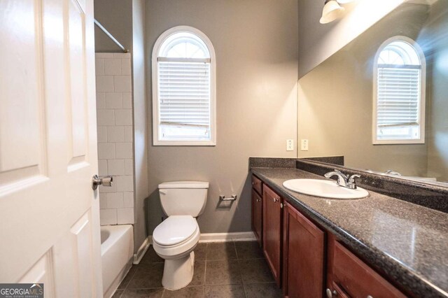 full bathroom featuring vanity, tile patterned floors, toilet, and a wealth of natural light