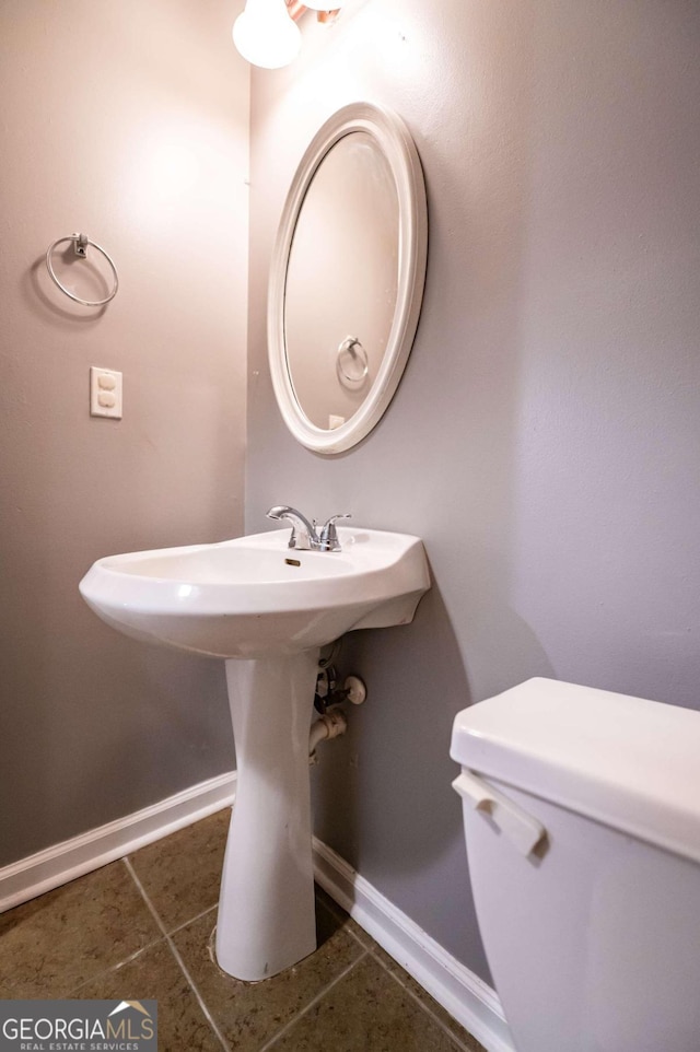 bathroom with tile patterned flooring, sink, and toilet