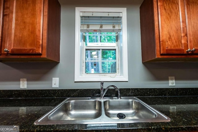 kitchen with dark stone counters and sink